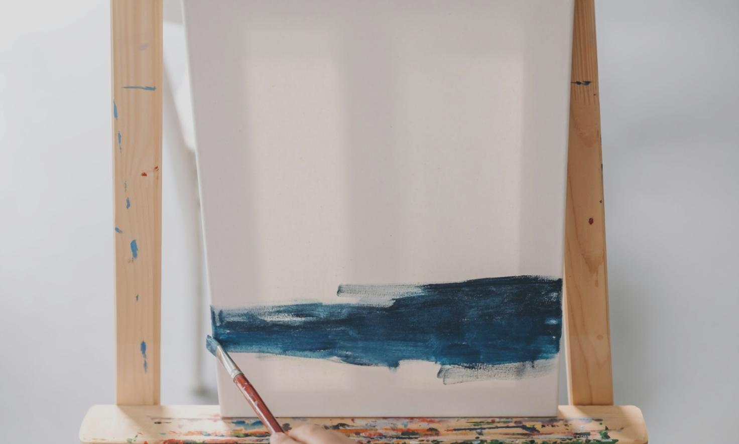 Concept artist working on a digital environment painting during a live webinar session